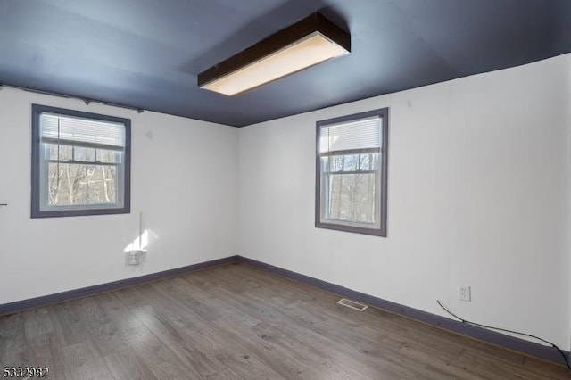 spare room featuring wood-type flooring