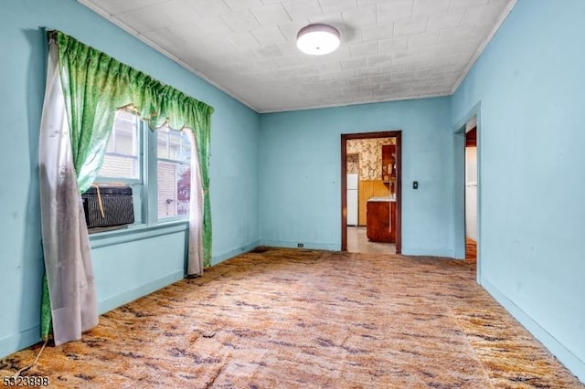 spare room featuring light carpet and cooling unit