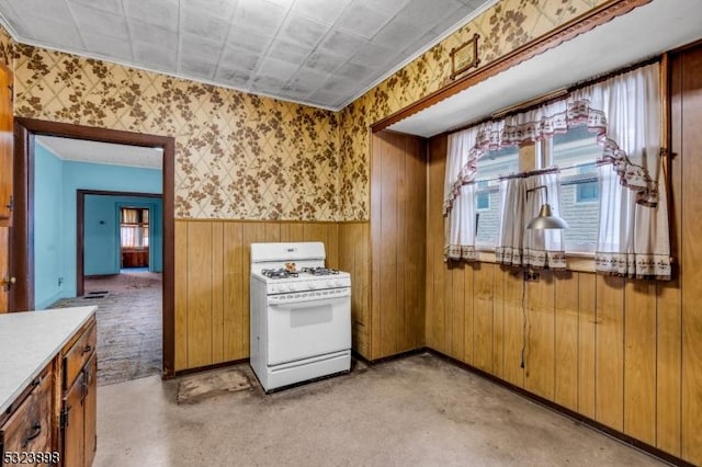 kitchen with white range with gas cooktop and light carpet