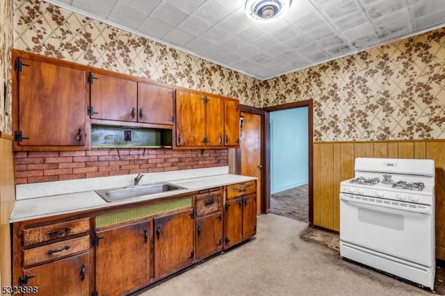 kitchen featuring light colored carpet, sink, and white range with gas cooktop