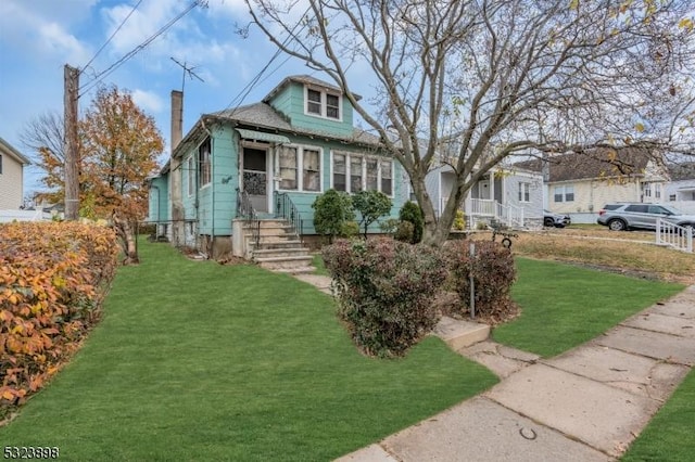 bungalow-style house with a front lawn