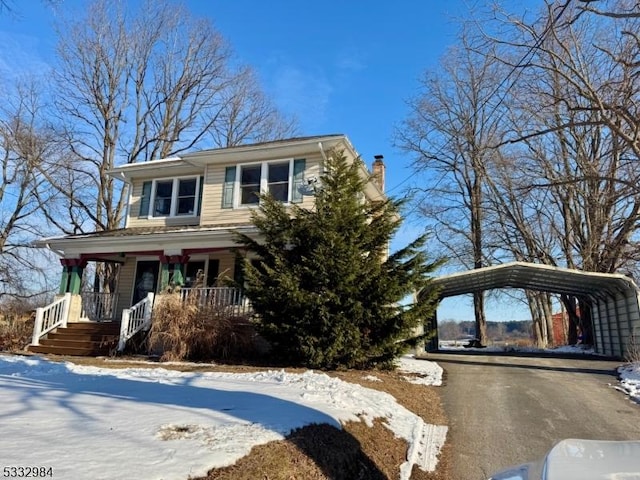 view of front of house featuring a carport and a porch