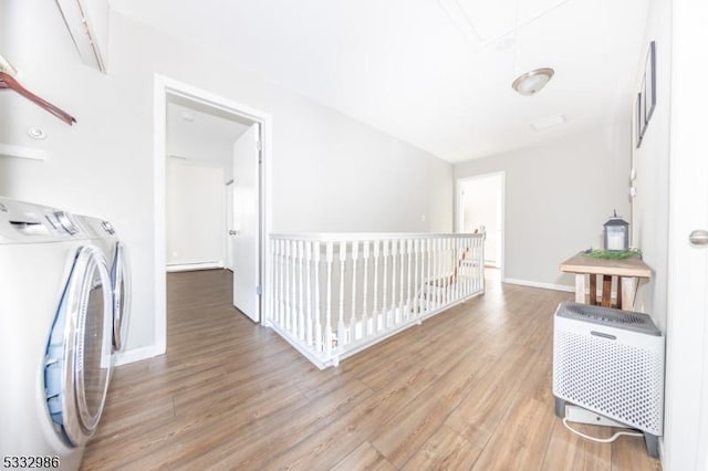 washroom featuring hardwood / wood-style floors and washing machine and dryer