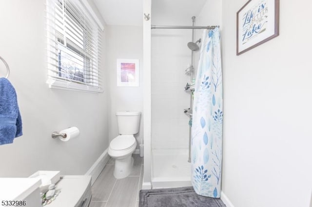 bathroom featuring curtained shower, toilet, and vanity