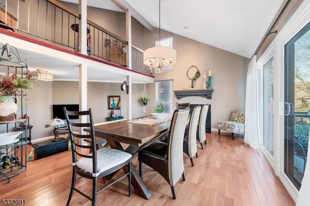 dining space with a chandelier, high vaulted ceiling, and wood-type flooring