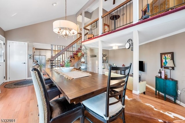 dining area featuring crown molding, light hardwood / wood-style floors, and a chandelier