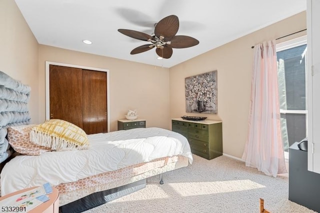 bedroom featuring a closet, ceiling fan, and carpet flooring