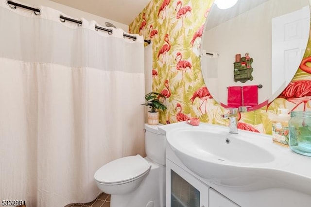 bathroom with vanity, toilet, and tile patterned flooring