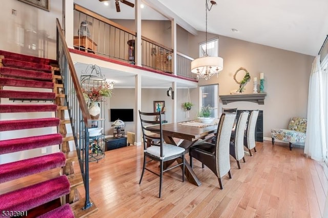 dining room featuring wood-type flooring, high vaulted ceiling, and a notable chandelier