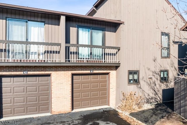 exterior space with a garage and a balcony