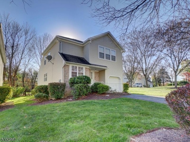 view of home's exterior featuring a lawn and a garage