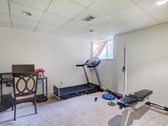 exercise area with a paneled ceiling and carpet floors