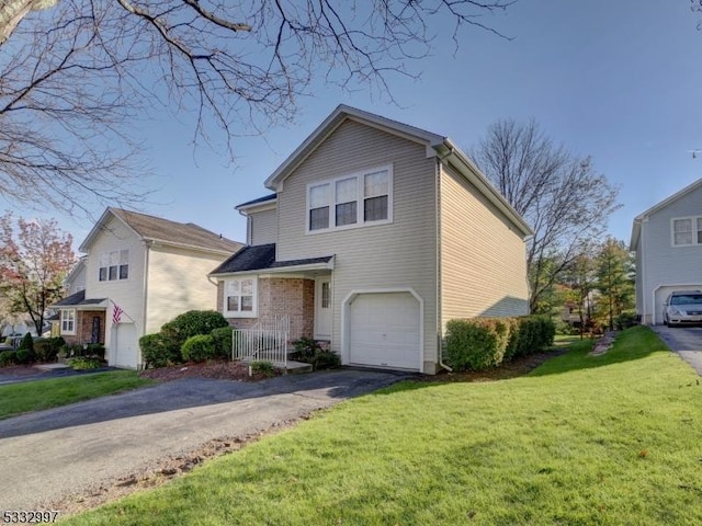 front of property with a garage and a front lawn