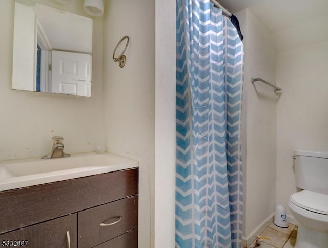 bathroom with toilet, curtained shower, tile patterned floors, and vanity