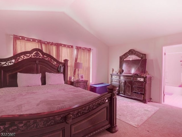 carpeted bedroom with lofted ceiling and ensuite bathroom