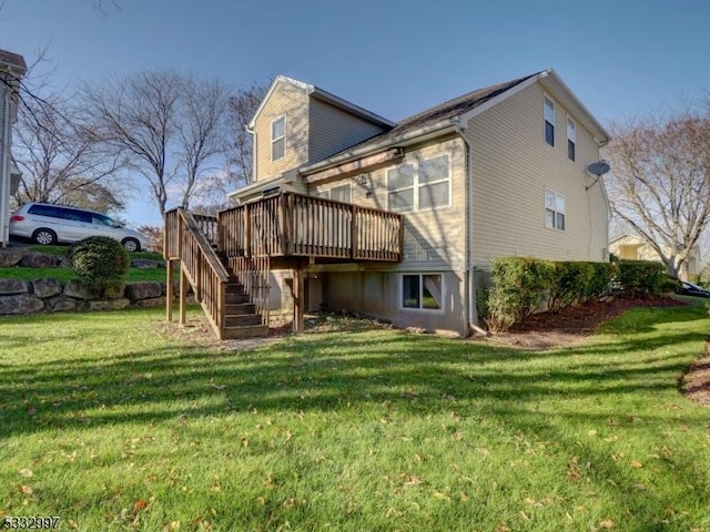 rear view of house with a lawn and a deck