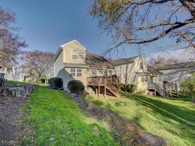 rear view of property with a lawn and a wooden deck