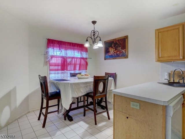 tiled dining room featuring a notable chandelier and sink