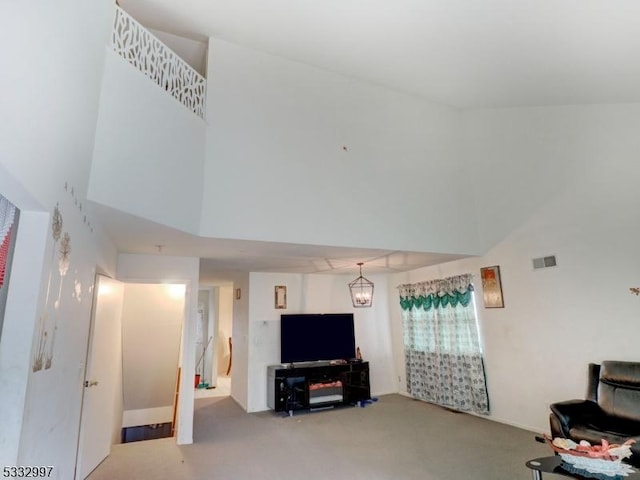 living room with a notable chandelier and carpet flooring