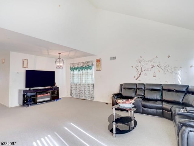 carpeted living room with a notable chandelier