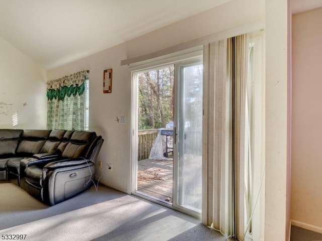 doorway to outside featuring carpet flooring