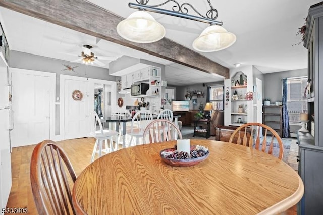 dining room with ceiling fan and light hardwood / wood-style floors