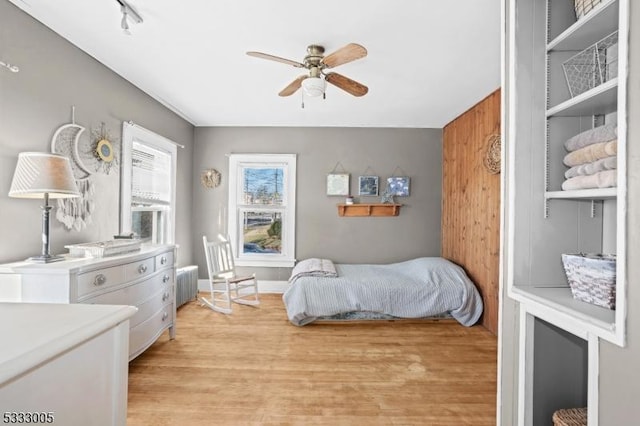 bedroom featuring radiator, ceiling fan, and light wood-type flooring