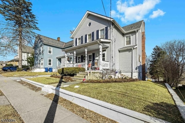 view of front property featuring a front yard and covered porch