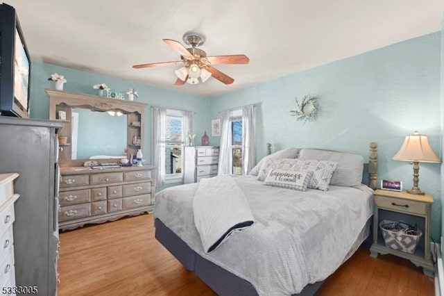 bedroom featuring ceiling fan and light hardwood / wood-style flooring