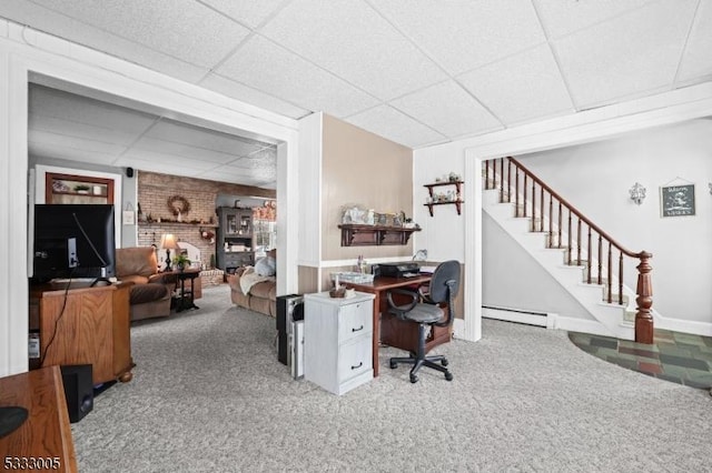 carpeted office with baseboard heating and a drop ceiling