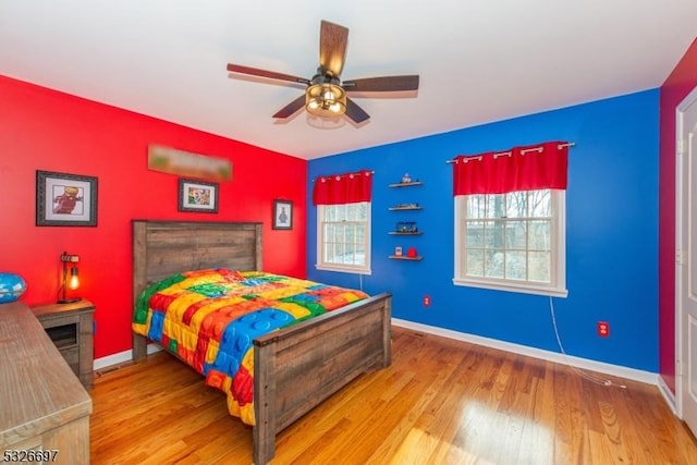 bedroom with ceiling fan and hardwood / wood-style flooring