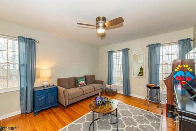 living room with ceiling fan, a healthy amount of sunlight, and light hardwood / wood-style floors