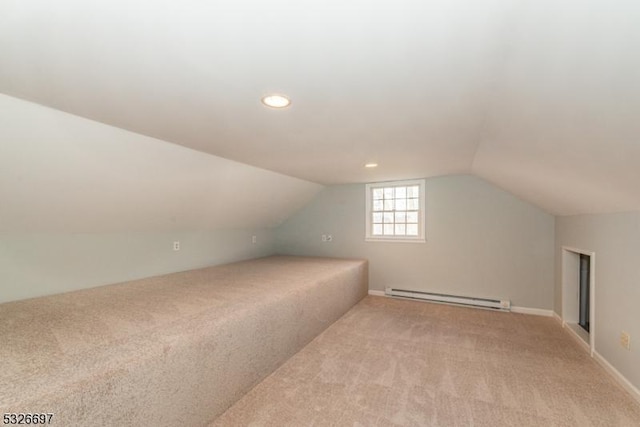 bonus room featuring a baseboard heating unit, lofted ceiling, and light carpet