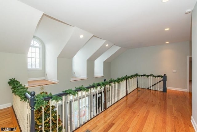 bonus room featuring vaulted ceiling and hardwood / wood-style flooring