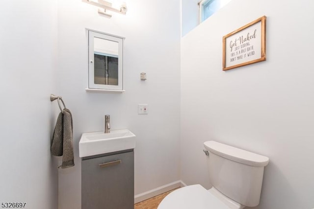 bathroom featuring toilet and vanity