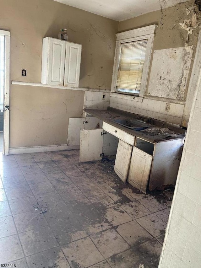 kitchen featuring sink and white cabinetry