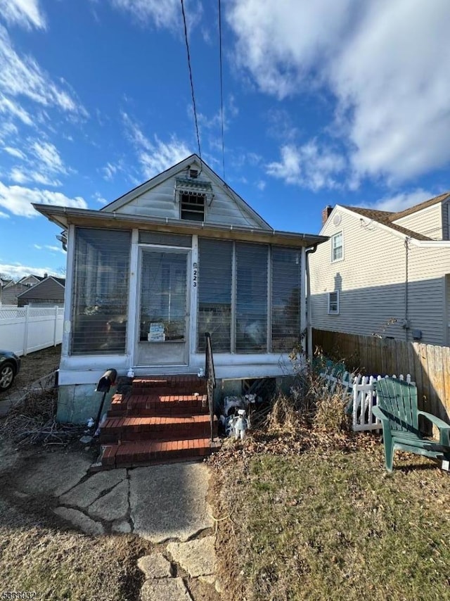 back of house with a sunroom