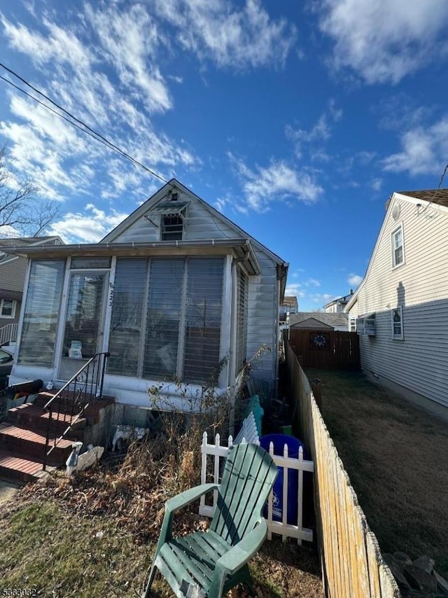 view of side of home with a sunroom