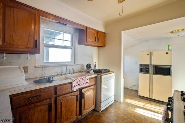 kitchen featuring white appliances, sink, and dark parquet flooring