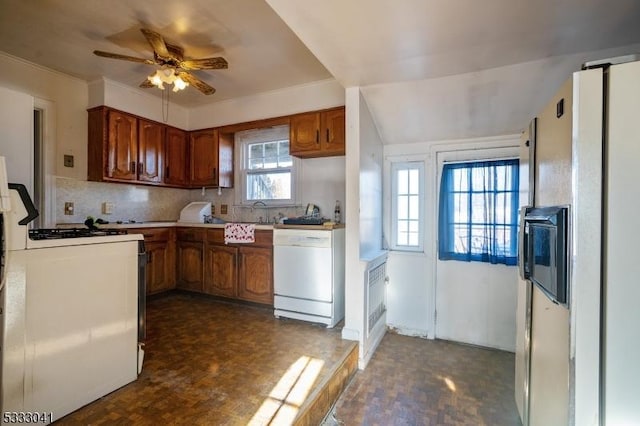 kitchen with white appliances, ceiling fan, backsplash, and dark parquet flooring