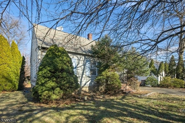 view of side of property with a lawn