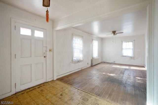 entrance foyer with ceiling fan, plenty of natural light, and radiator