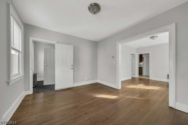 spare room with dark hardwood / wood-style flooring