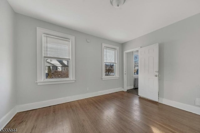 spare room with dark wood-type flooring