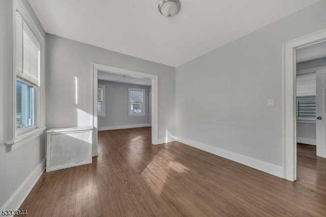 unfurnished room featuring dark hardwood / wood-style floors