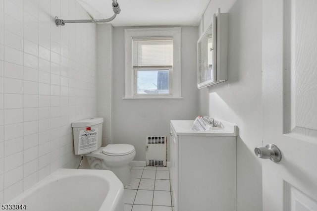 bathroom featuring toilet, tile patterned floors, sink, a bathing tub, and radiator