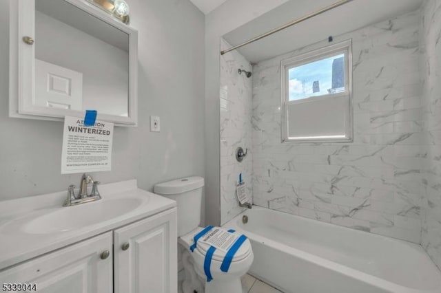 full bathroom with toilet, vanity, tiled shower / bath combo, and tile patterned flooring