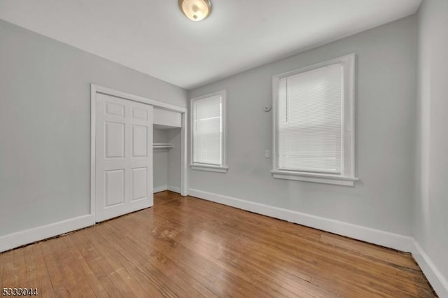 unfurnished bedroom featuring a closet and light hardwood / wood-style floors