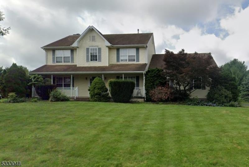 view of front of property featuring covered porch and a front yard