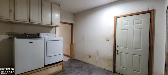 laundry room with washer and dryer and cabinets